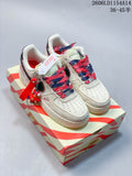 Pair of cream Nike Air Force 1 '07 low-top sneakers with red and navy accents and a character keychain
