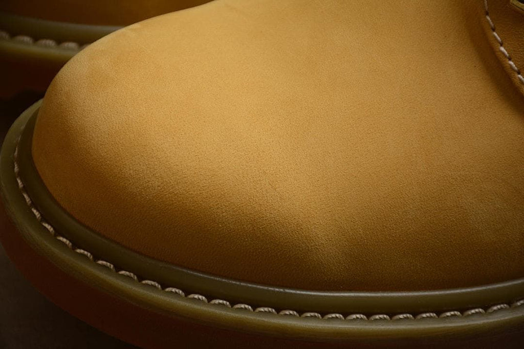Close-up of the yellow toe and stitched edge above the outsole