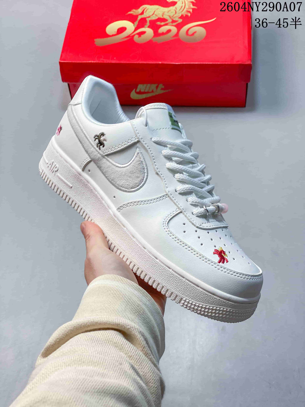 Angled view of the white sneaker with textured Swoosh and horse-themed embroidery.