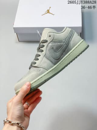 Side view of a gray and green Air Jordan 1 Low sneaker.