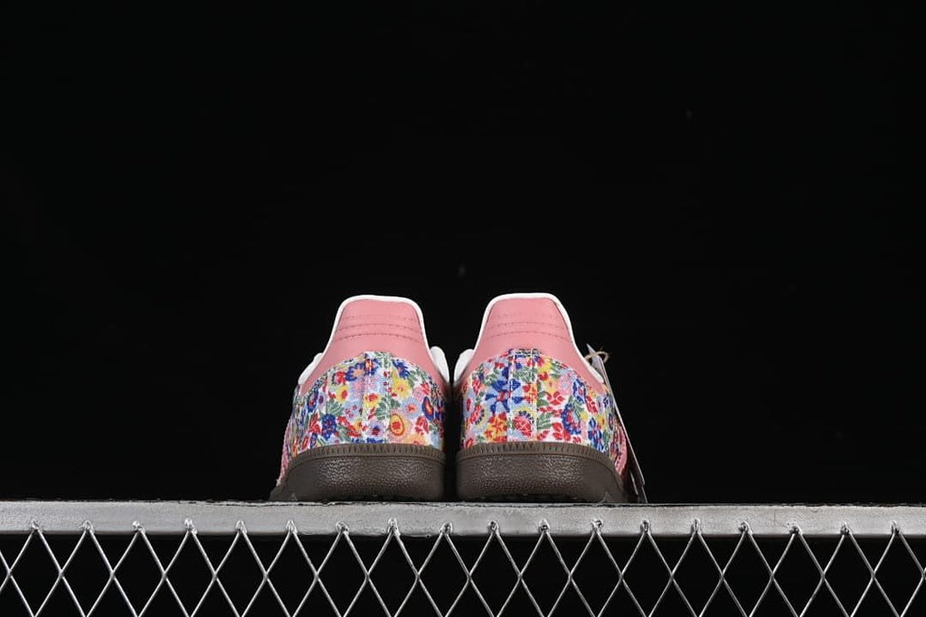 Rear view of the pair showing floral-print heel panels and pink heel tabs