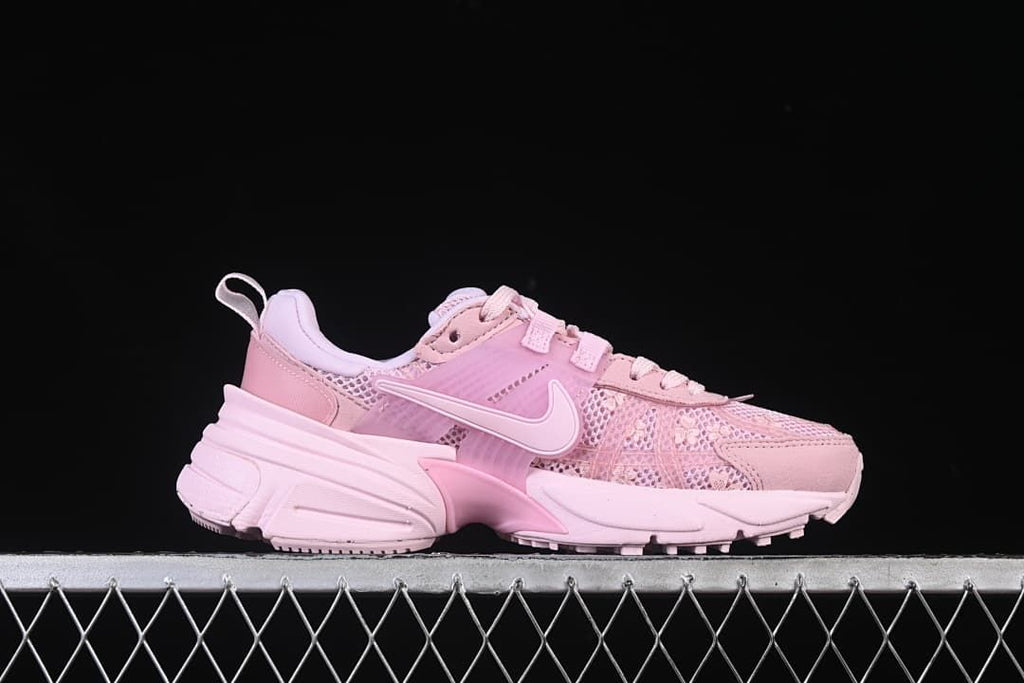 Side profile of the pink low-top sneaker with floral-patterned panels and sculpted sole.