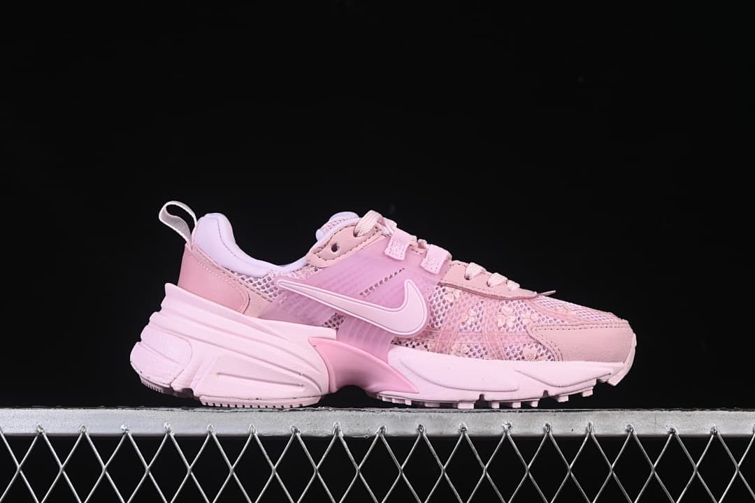 Side profile of the pink low-top sneaker with floral-patterned panels and sculpted sole.