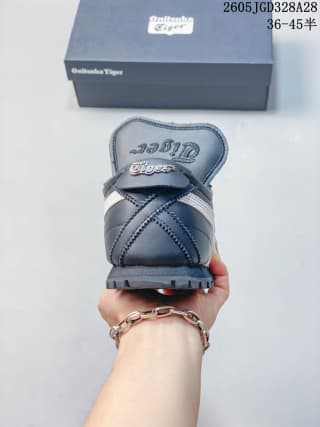 Rear view of a navy Onitsuka Tiger MEXICO 66 GOLF sneaker with a fold-over tongue flap