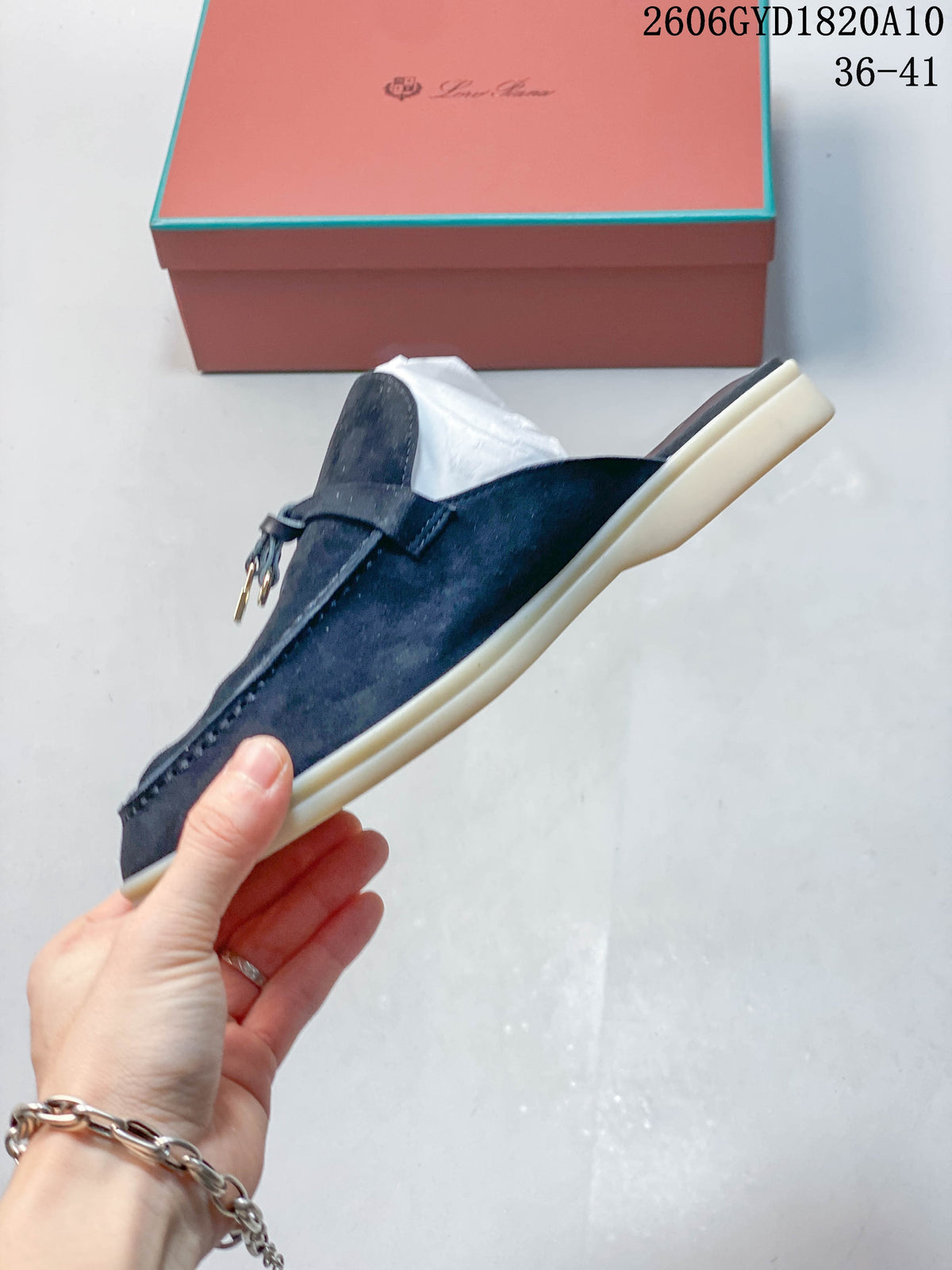 Side view of a navy lock-detail mule loafer with a light-colored sole; photo overlay shows style code 2606GYD1820A10 and sizes 36–41.