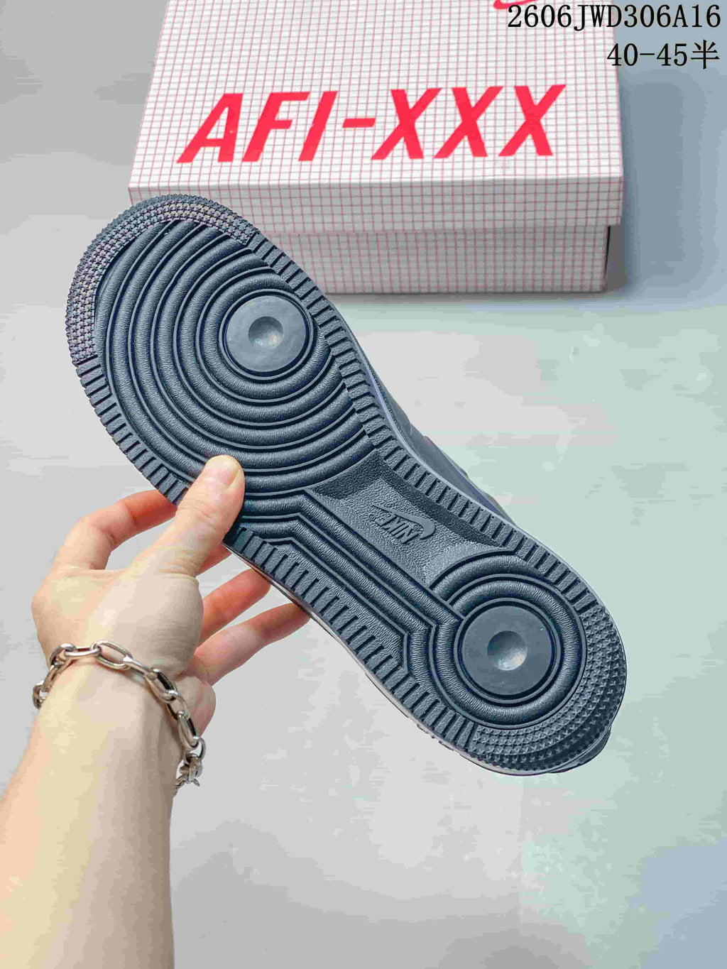 Underside of the sneaker showing circular tread details and patterned outsole
