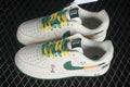 Pair of white Nike Air Force 1 '07 Low sneakers with green and yellow laces, green Swooshes, orange accents, and Brazil 2026 graphics.