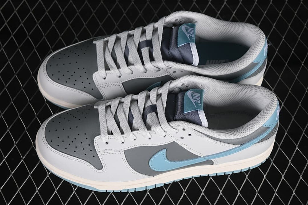 Pair of grey, white, and blue low-top sneakers