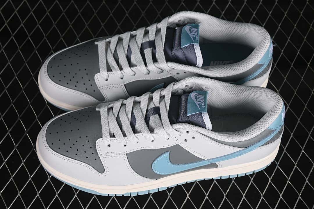 Pair of grey, white, and blue low-top sneakers