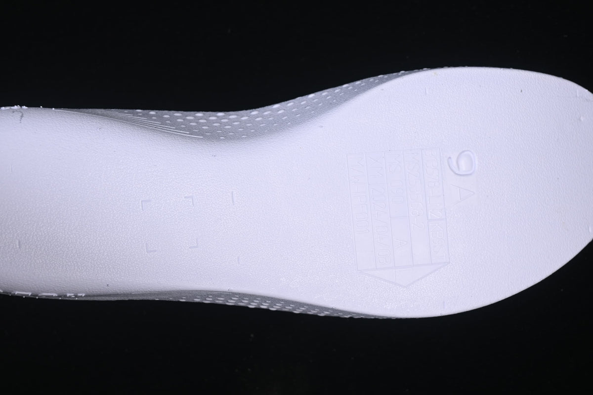 Close-up of a light-colored insole with embossed markings.