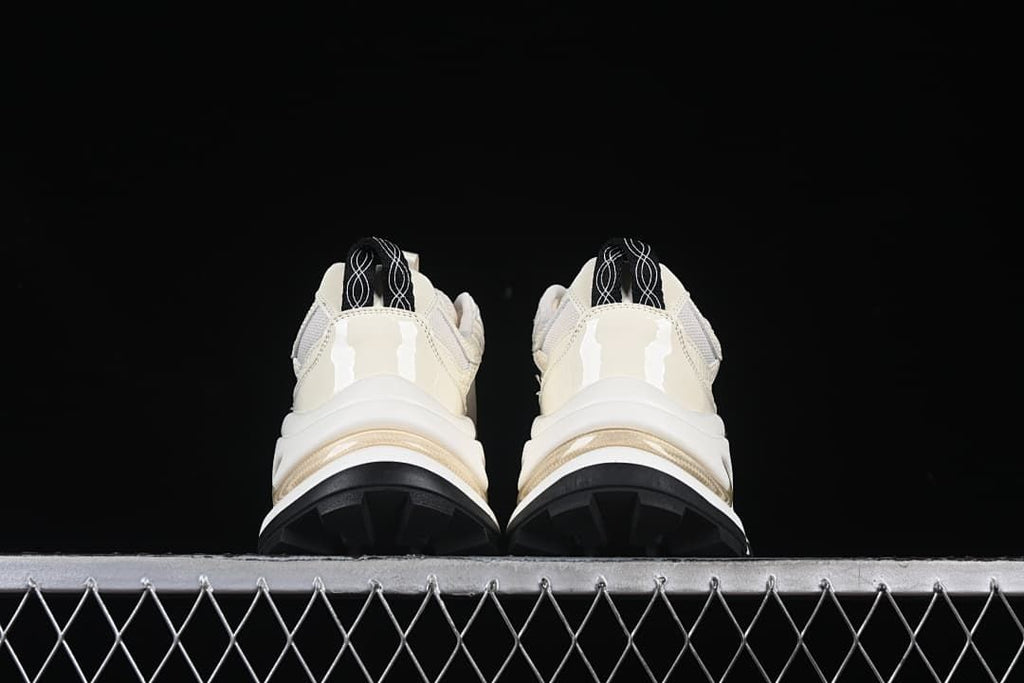 Rear view of both sneakers showing heel details and black tread