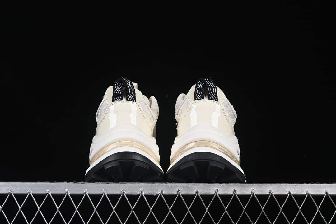 Rear view of both sneakers showing heel details and black tread