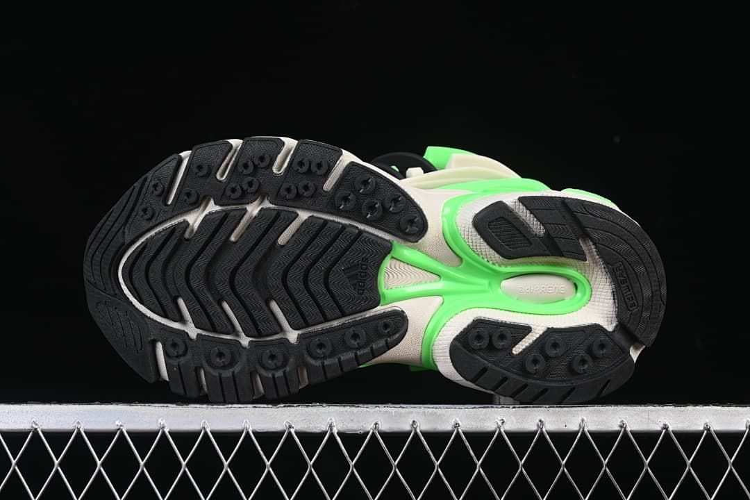 Underside view showing the black rubber outsole tread and bright green detailing.