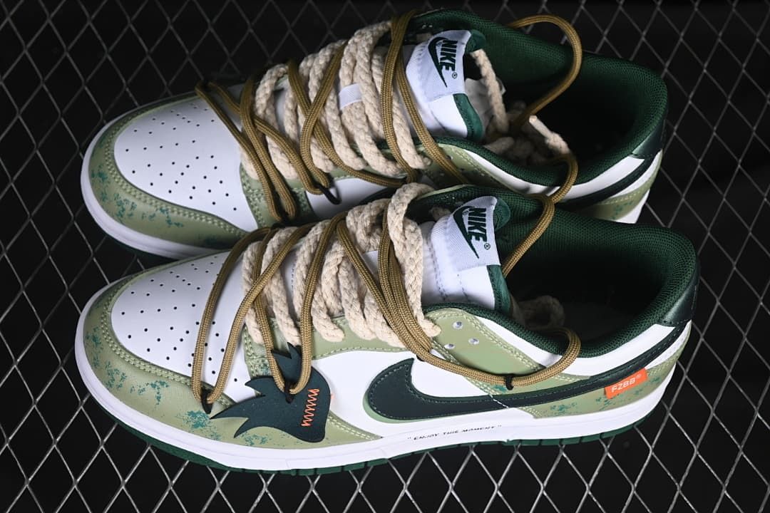 Pair of white and green low-top sneakers with layered laces