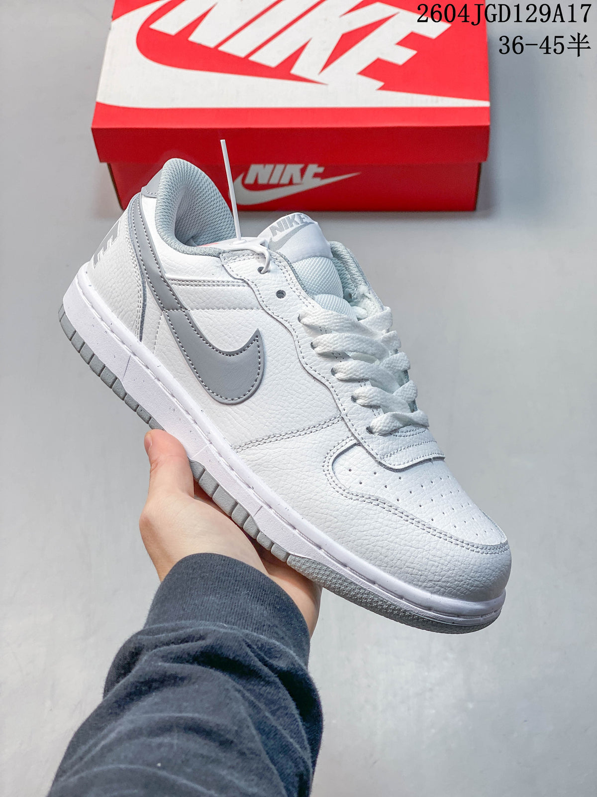 Side view of a white Nike Big Low sneaker with gray Swoosh and outsole accents.