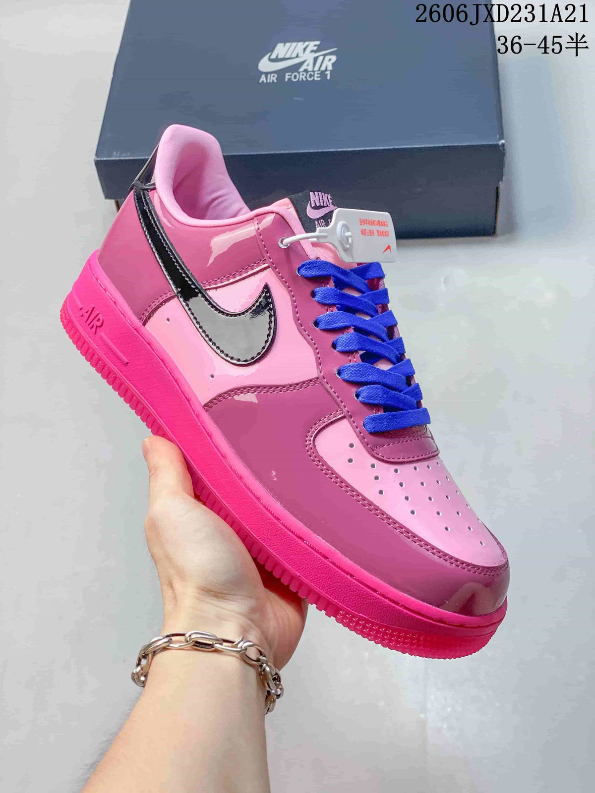 Close side view of a pink Nike Air Force 1 sneaker with a glossy dark Swoosh