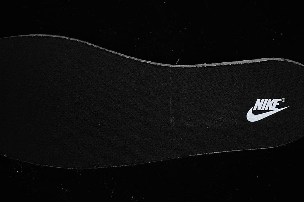Black insole with a white Nike logo.