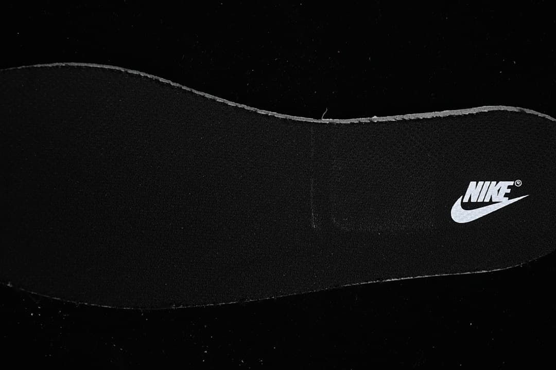 Black insole with a white Nike logo.
