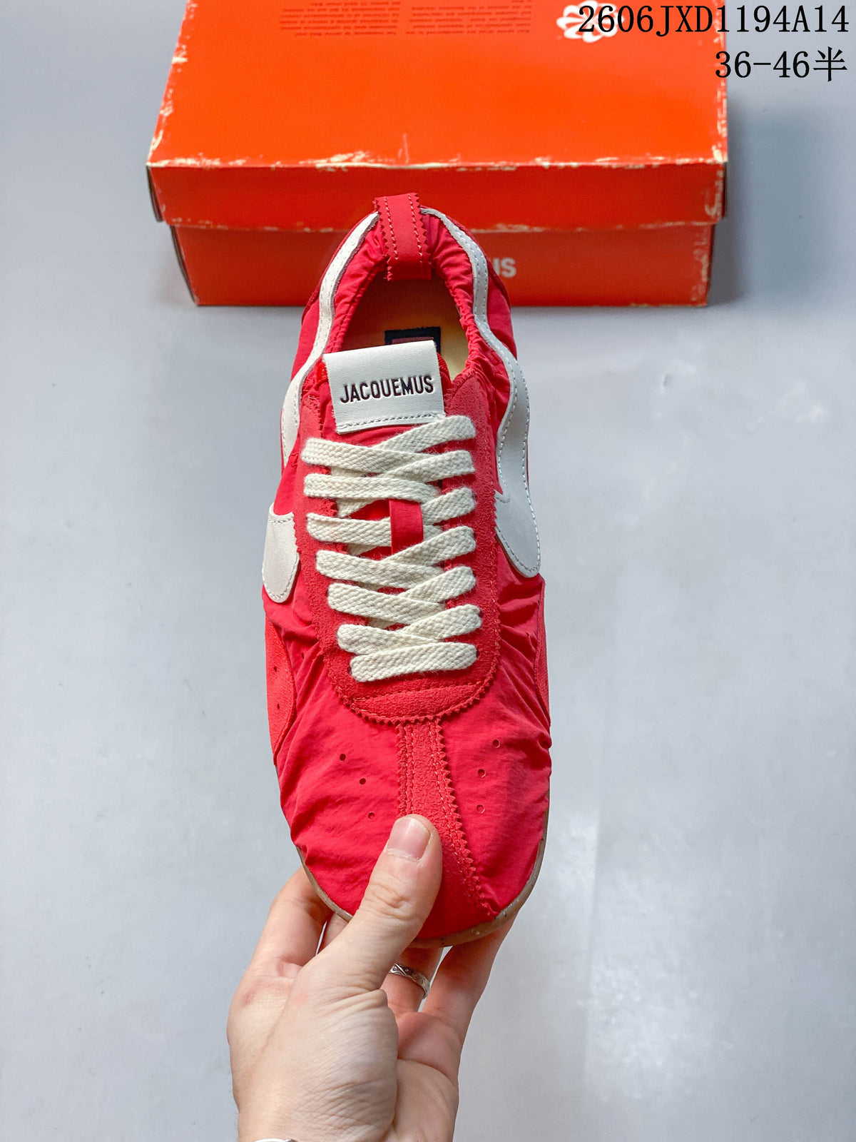 Front view showing the lace-up closure, tongue label, and red upper