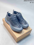 Pair of grey Reebok low-top sneakers displayed on a Reebok Classic box