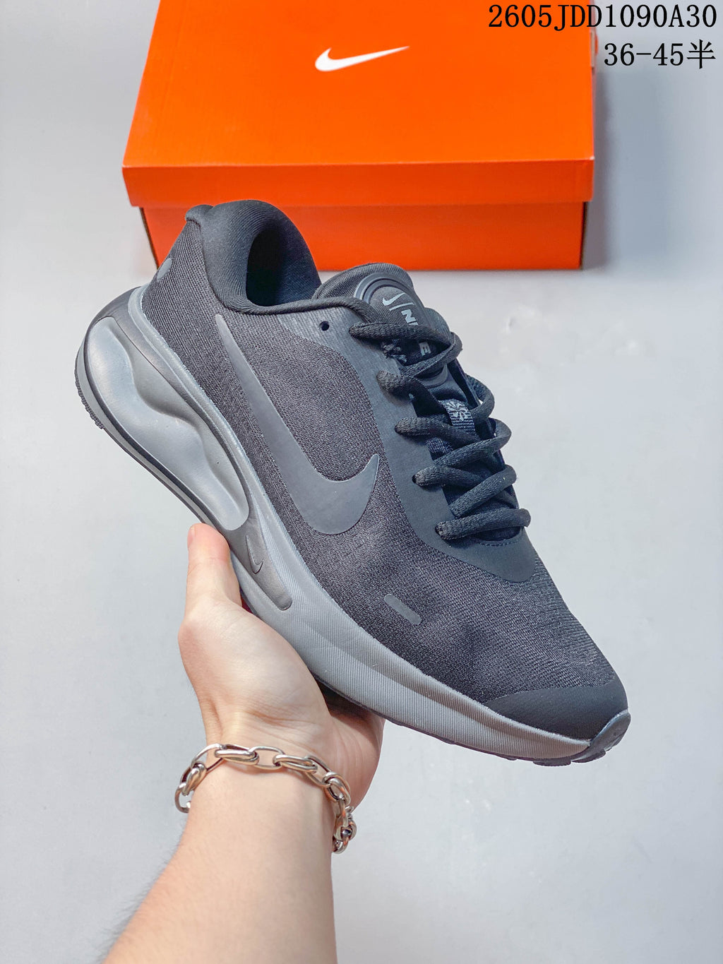 Side view of a dark gray Nike Journey Run shoe with a visible Swoosh and sculpted midsole.