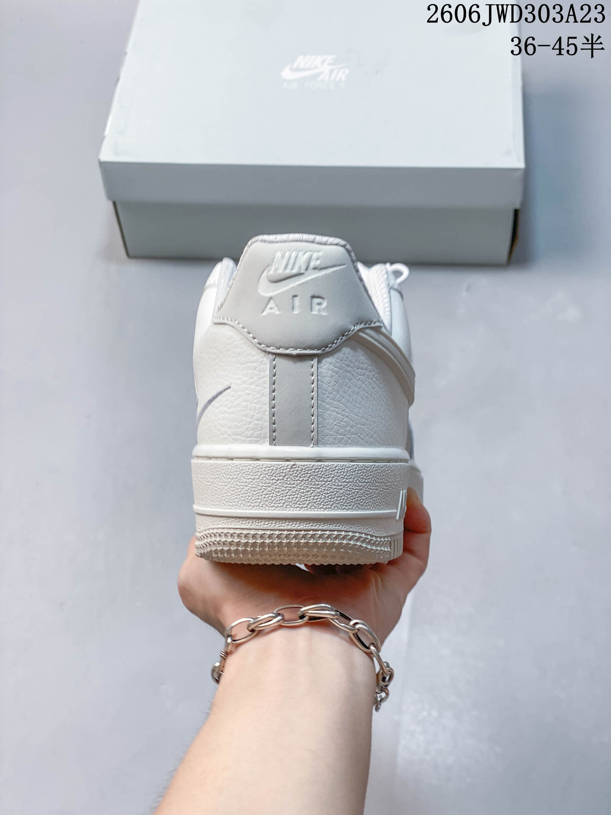 Rear view of a white low-top sneaker with heel branding