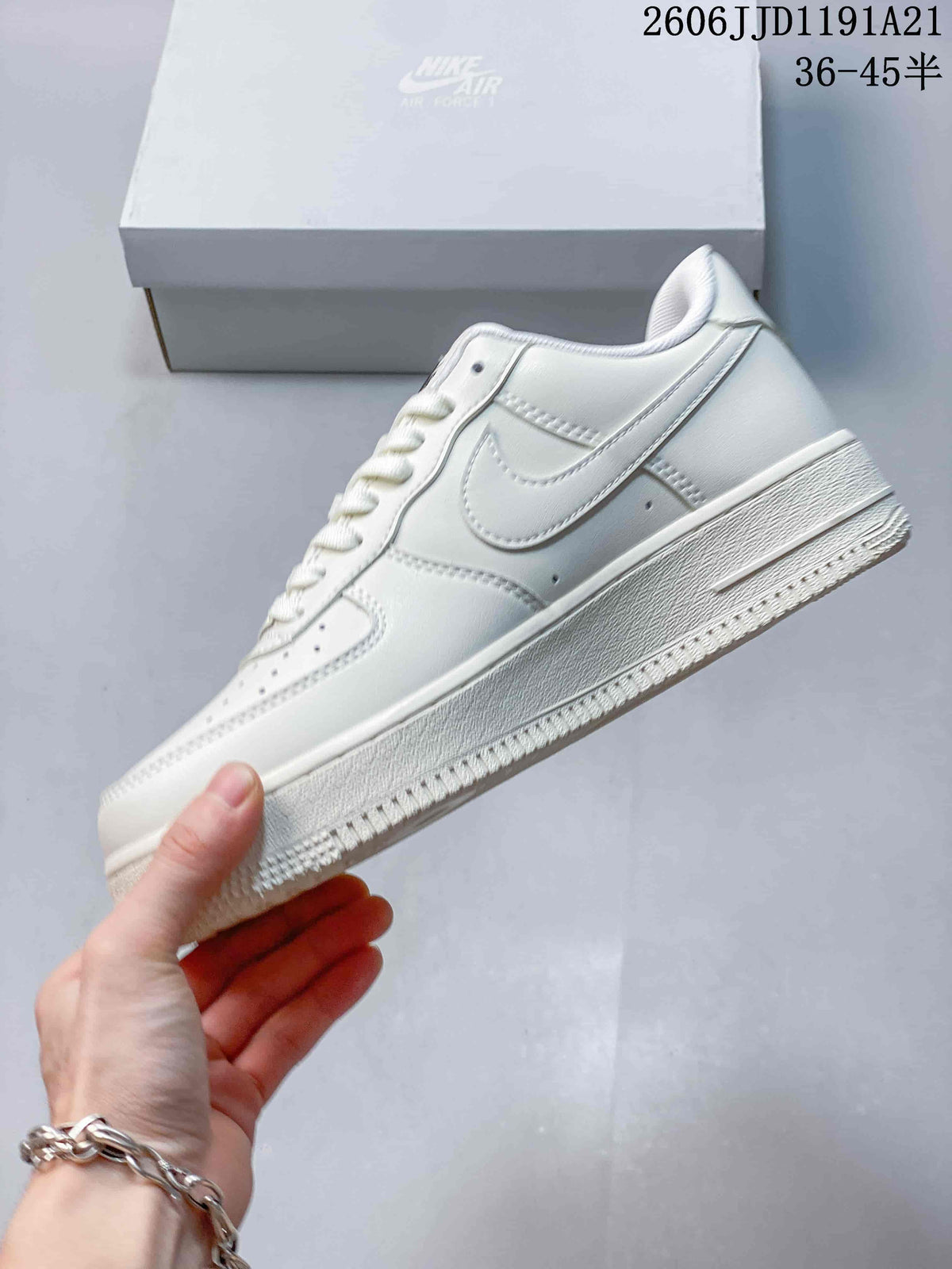Side view of a white low-top sneaker showing the Swoosh and textured sole