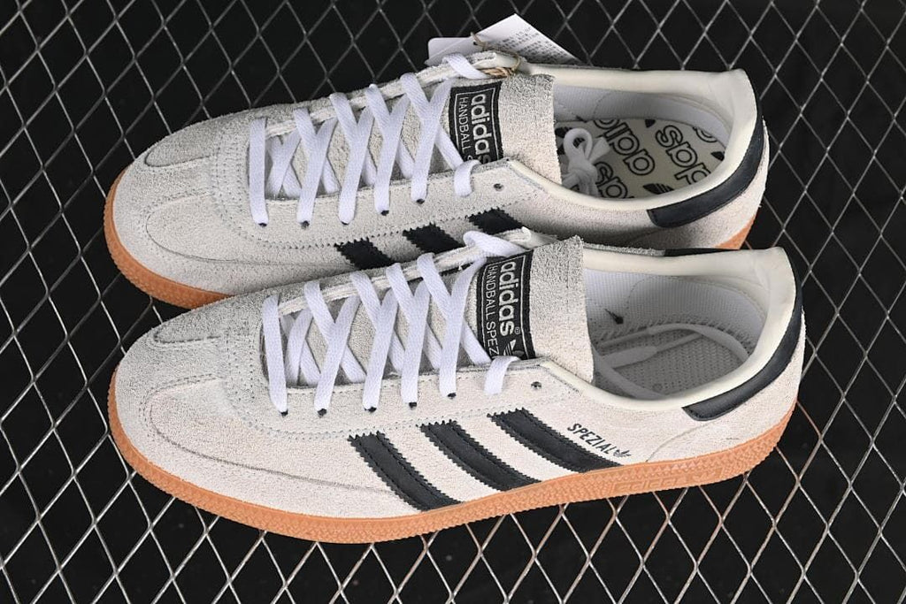 Pair of cream Handball Spezial sneakers with black stripes and gum soles