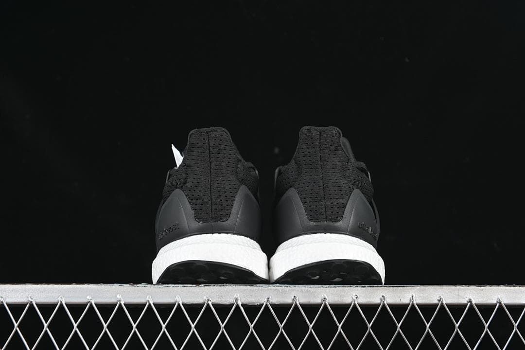 Rear view of the pair showing heel details and white midsoles.