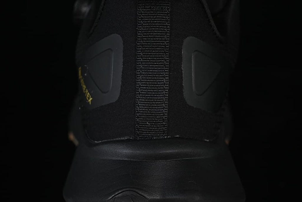 Rear view showing the black heel, pull tab, and side panels.