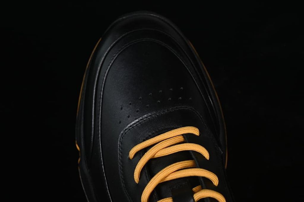 Top view of the perforated toe and amber lace-up front
