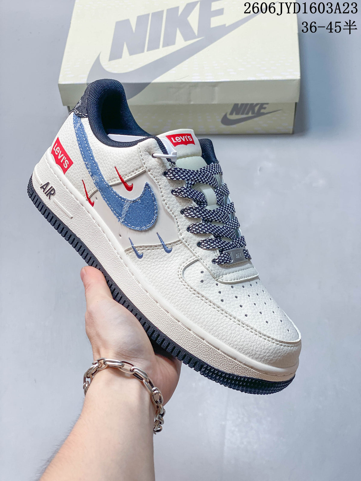 Angled side view showing the blue overlays, red labels, and dark outsole
