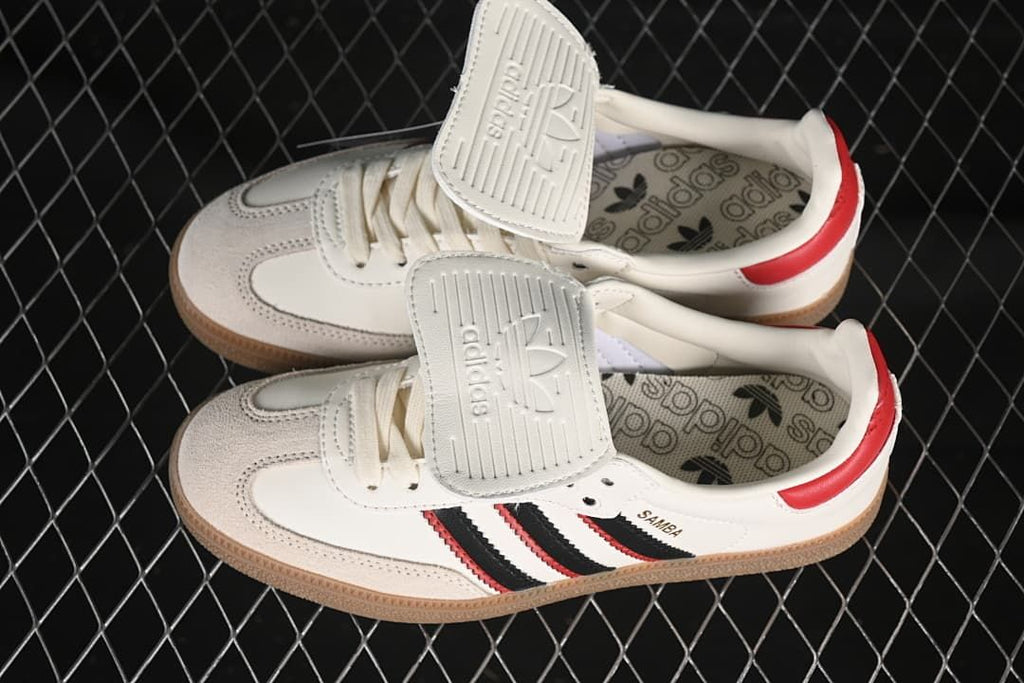 Pair of Samba LT sneakers showing the fold-over tongues and patterned insoles.