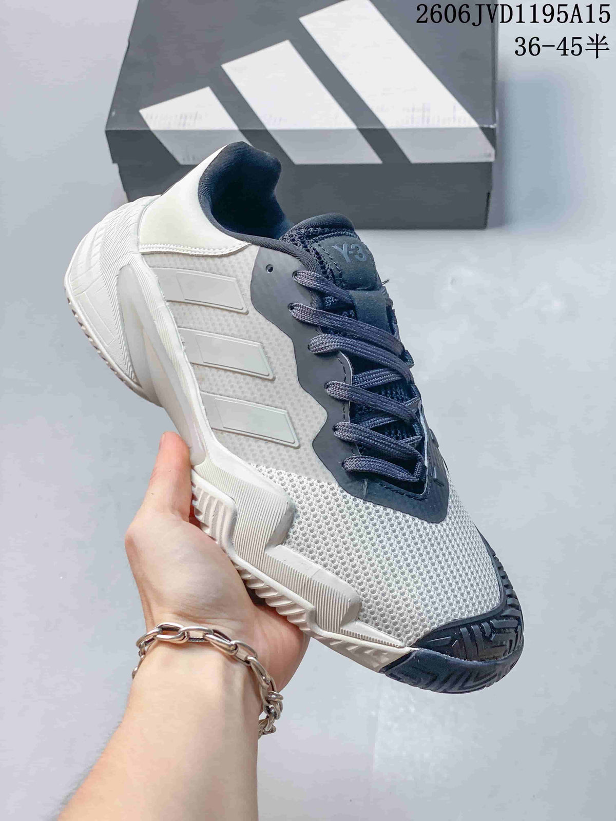 Side view of a white and dark gray Y-3 Barricade 13 sneaker.