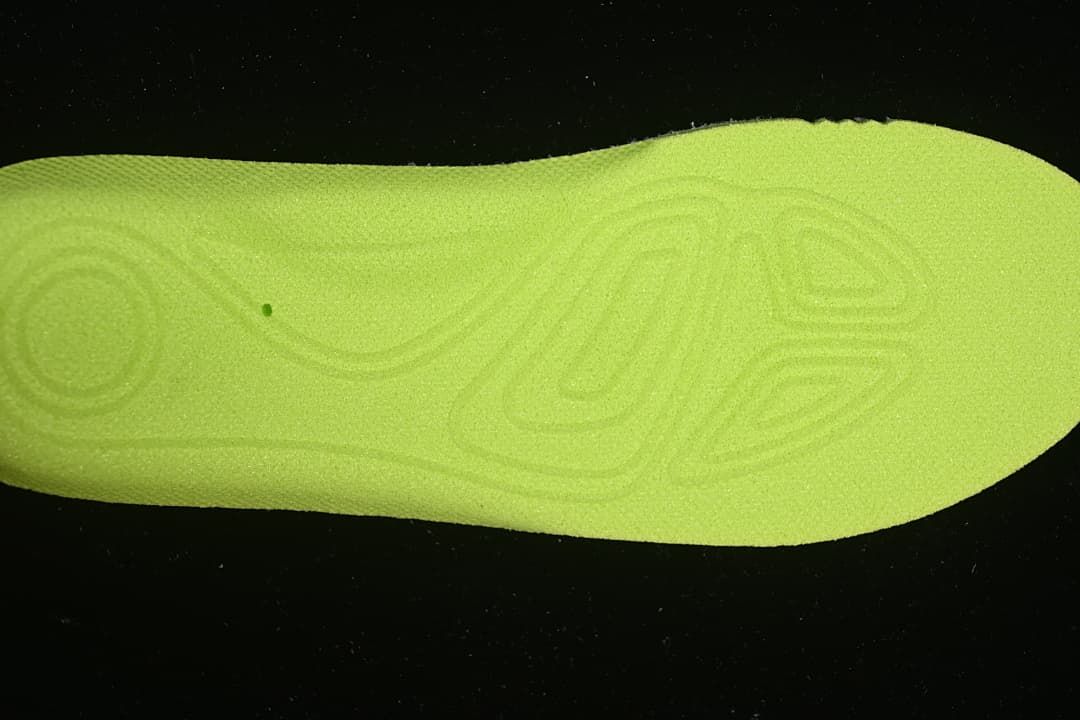 Close-up of a bright lime-colored shoe insole