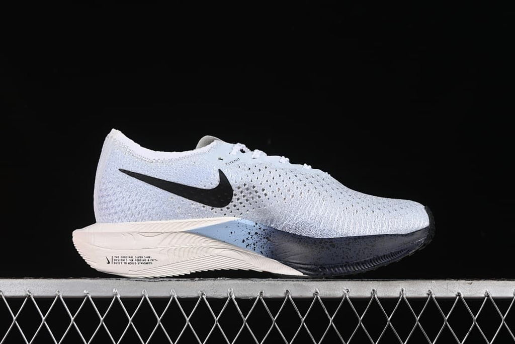 Side profile showing the white perforated upper and contrasting sole