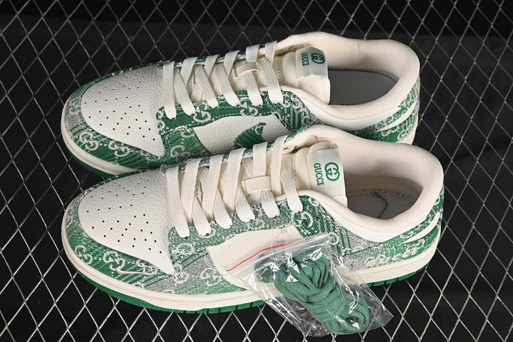 Pair of cream and green Nike SB Dunk Low sneakers with white laces and a spare set of green laces