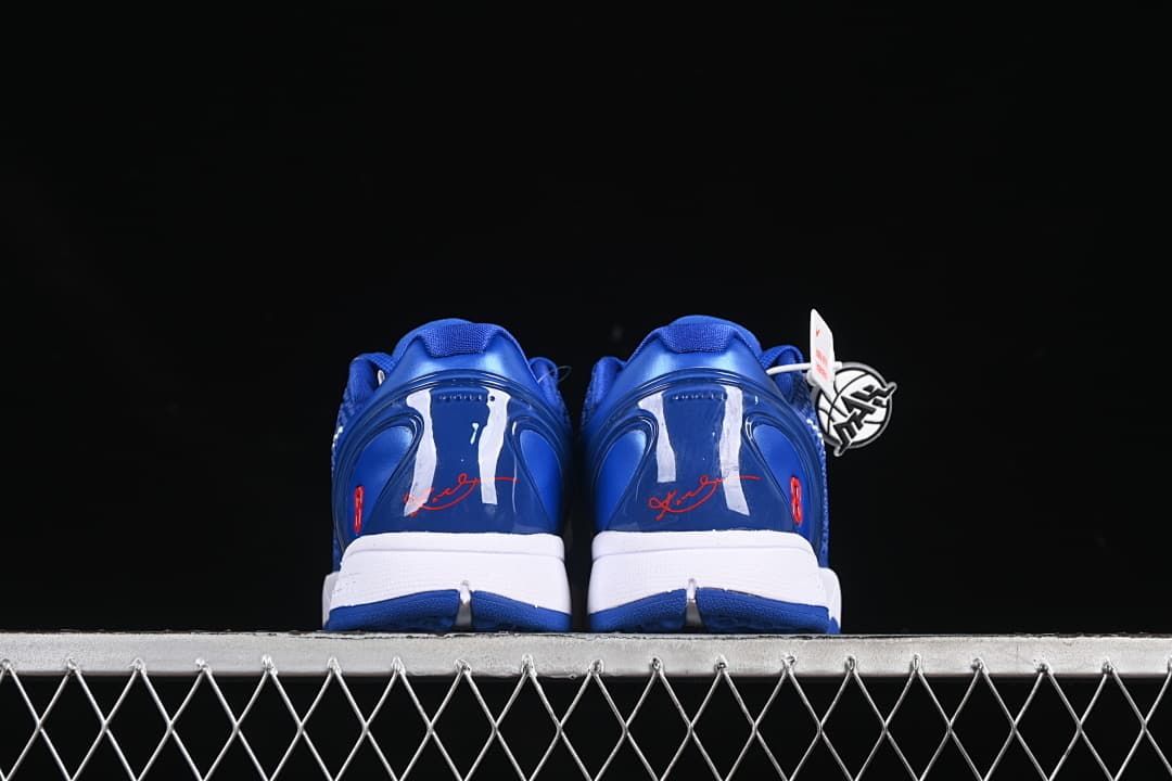 Rear view of both shoes showing blue heel counters and red signature details