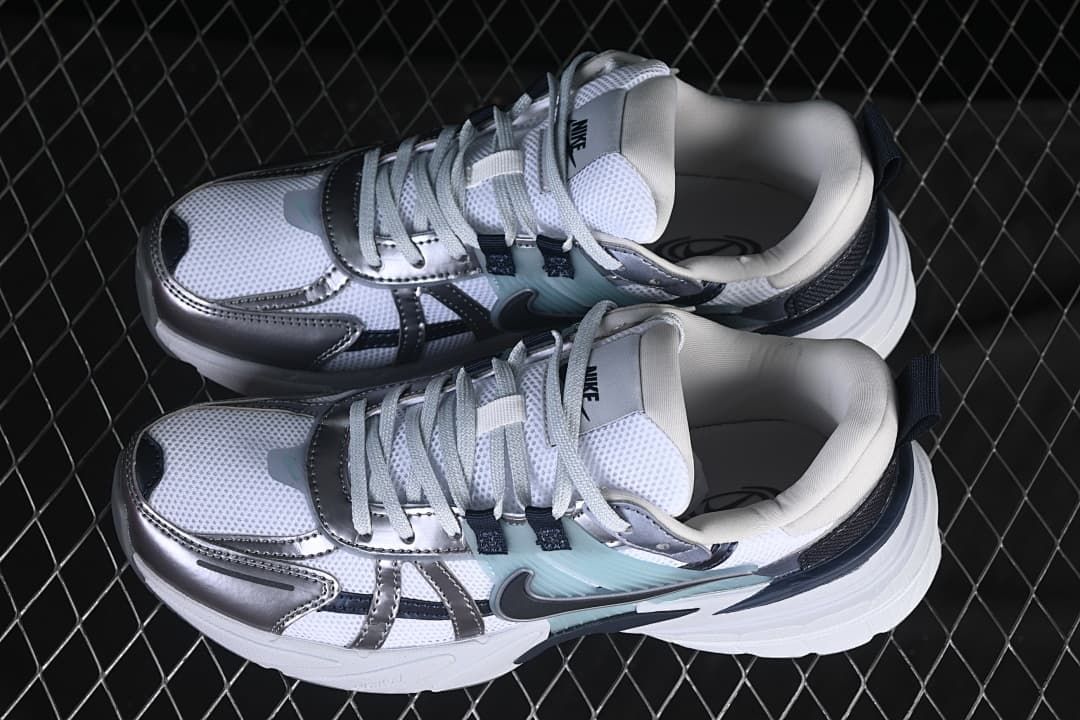 Pair of white and silver Nike V2K Run sneakers viewed from above.