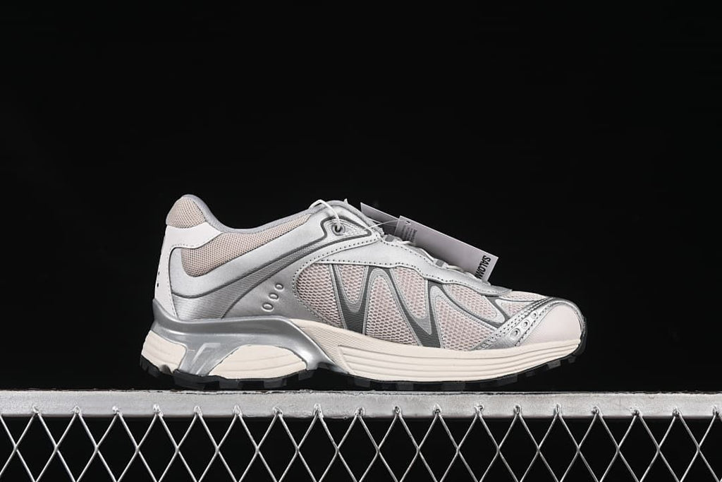 Opposite side profile of one silver and off-white sneaker.