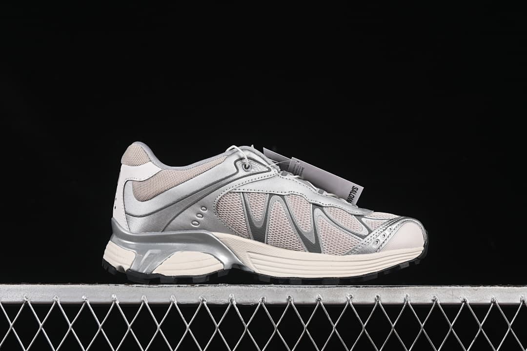Opposite side profile of one silver and off-white sneaker.