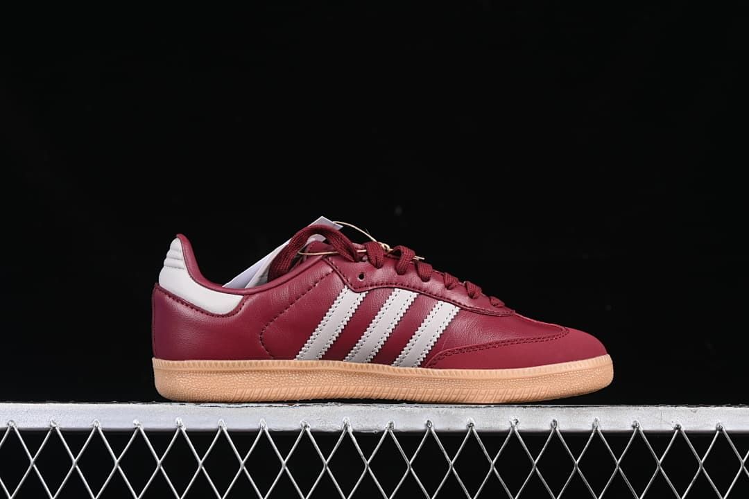 Side profile showing burgundy upper, white stripes and gum-colored outsole