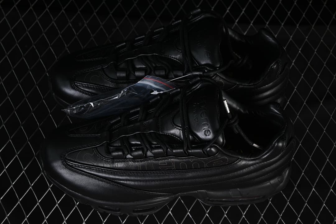 Pair of black sneakers with an extra lace packet