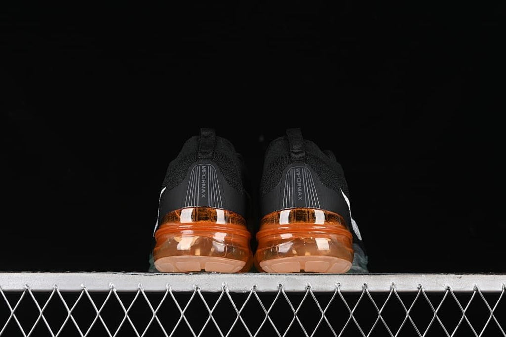 Rear view of the pair showing VaporMax heel branding and orange soles.