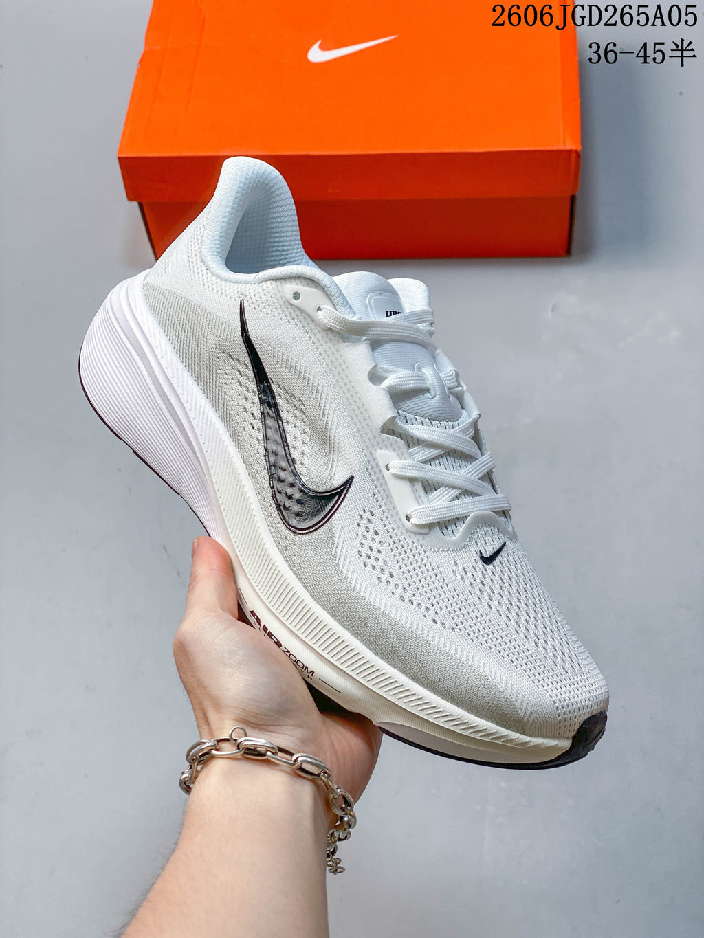 Angled side view of a white Nike Pegasus 42 running shoe with dark accents