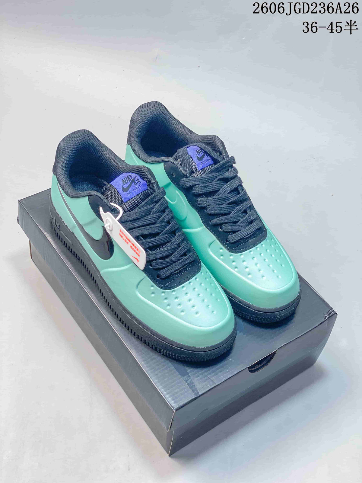 Pair of mint green Nike Air Force 1 '07 Low sneakers with navy accents