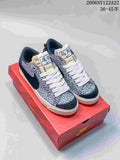 Pair of gray-and-black patterned Nike Blazer Low Jumbo sneakers with white laces