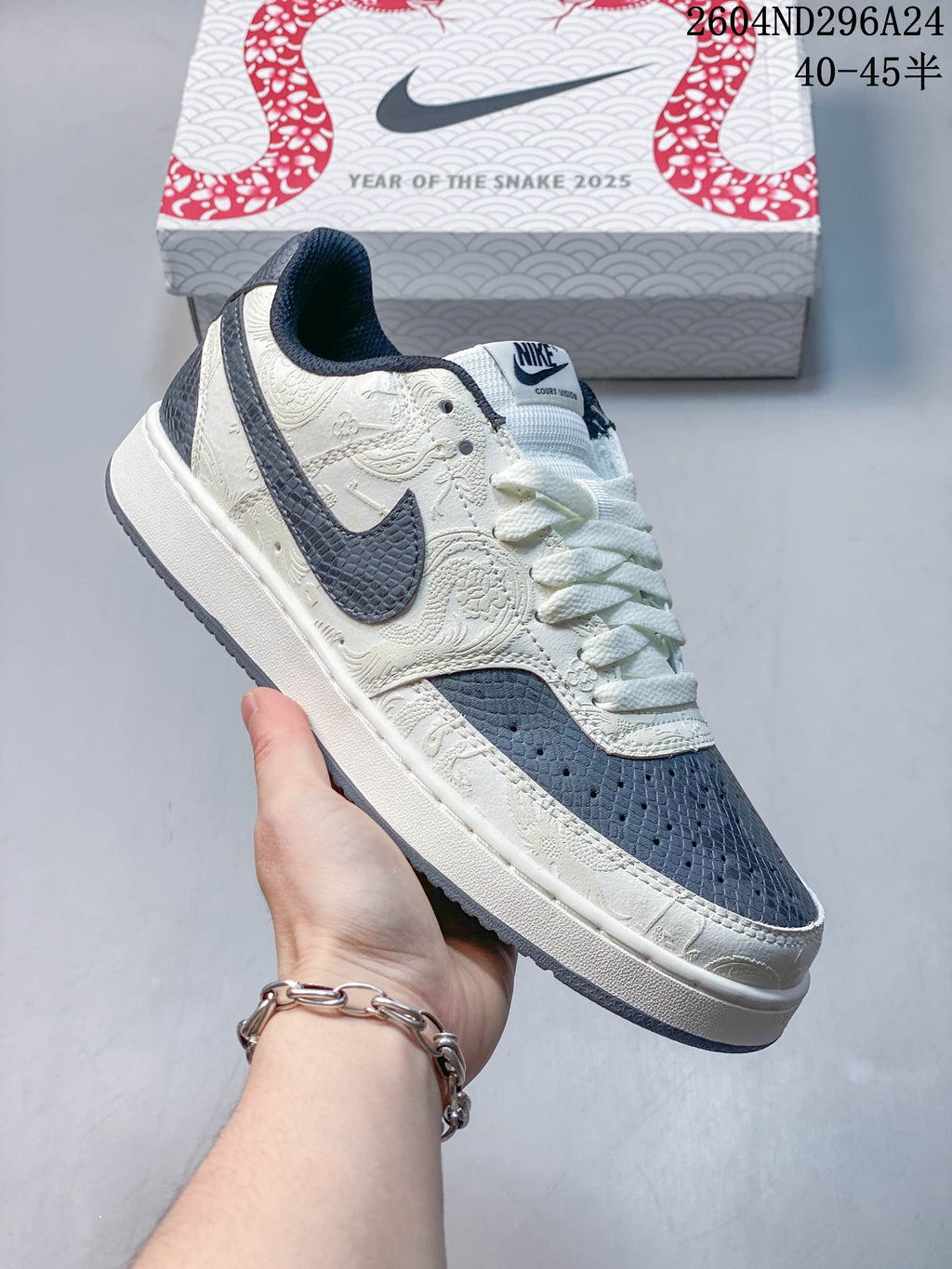 Close view of a navy and off-white Nike Court Vision Low sneaker with patterned accents