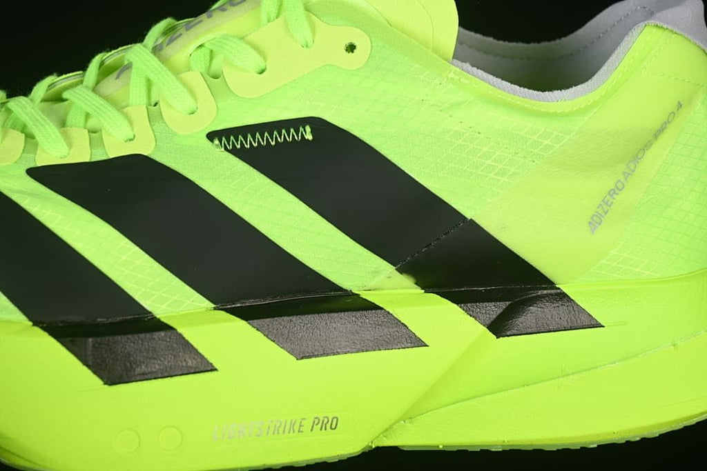 Close-up of black side stripes and shoe branding