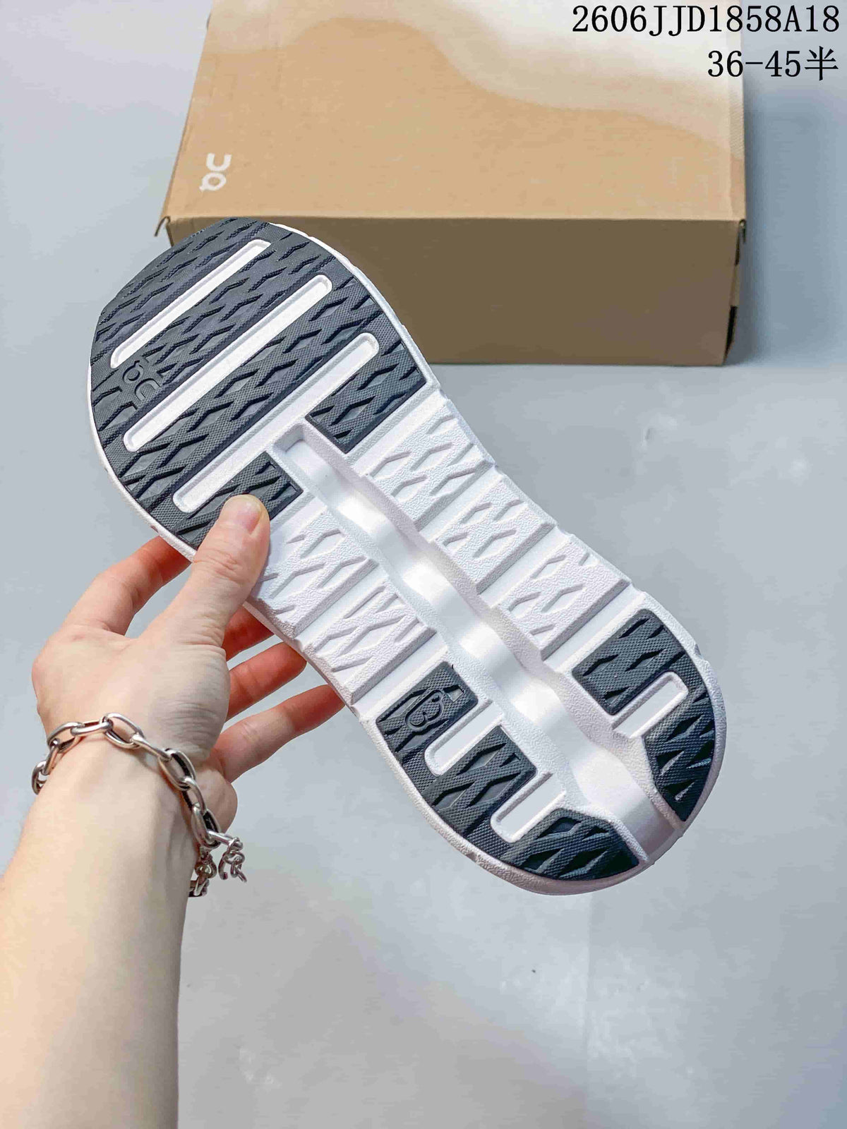 Underside of the sneaker showing a segmented grey and white outsole.